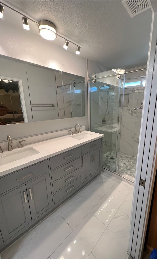 Modern bathroom vanity with glass shower enclosure - general contractor Inland Empire