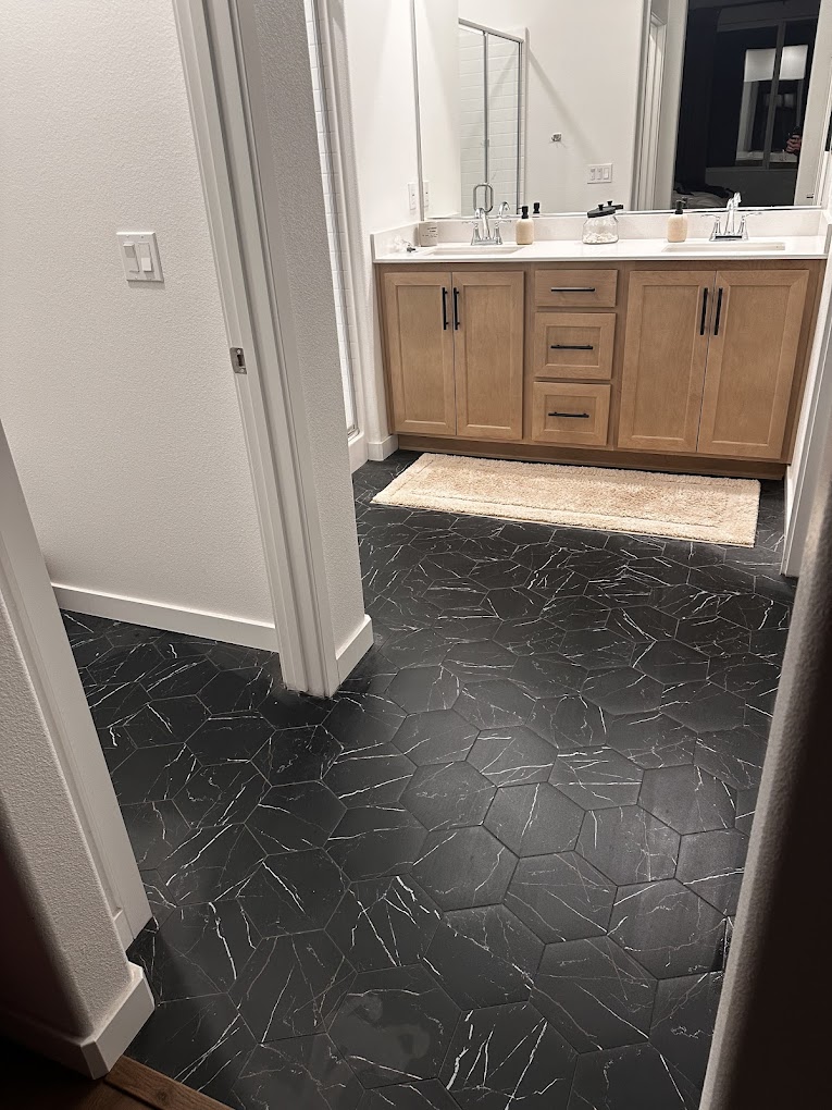 Black hexagonal marble tile bathroom floor - tile installation Inland Empire